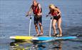Two people on stand up paddle boards.