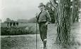 Historic picture with Baden Powell, (founder of the scouting movement) standing next to a tree.