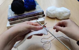 Knitting books, knitting needles and balls of wool