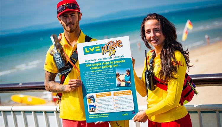 Lifeguards holding LV childrens safety poster
