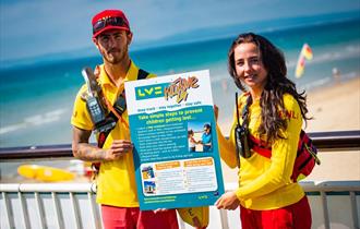 Lifeguards holding LV childrens safety poster
