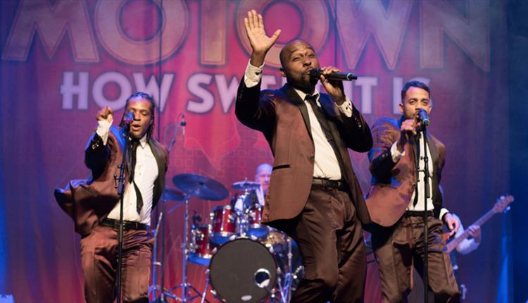 Image of Motown band on stage with matching suits