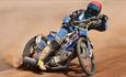 One of the Poole pirates skidding round the corner on the dirt track during a race