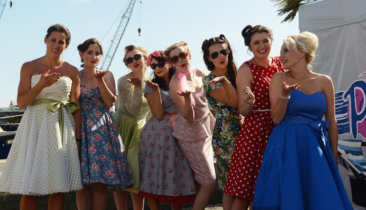 Ladies line up on Poole Quay in vintage clothes