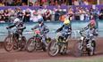 Four bikes side by side ready to start their race at the Speedway