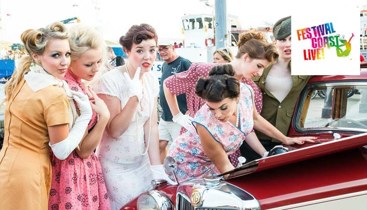 Ladies in vintage clothing standing around vintage car