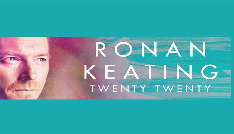 Ronan Keating headshot with blue and purple pastel background.