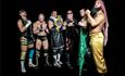 Superslam Wrestling, group of several wrestlers standing a posing to camera in dress up in glittery, black, gold, green outfits against a black backgr