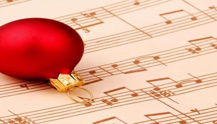 A red bauble on a hymn sheet