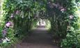 Archway leading through the priory gardens as part of the flower trail
