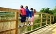 Group of children standing on the fence looking at the views from the park