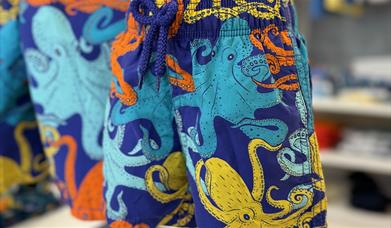 Swim shorts with a multi-coloured octopus design