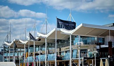 A Gunwharf Quays flag flying near the centre's restaurants