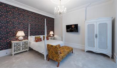 Modern four-poster bed in a room at The Clarence Boutique Rooms