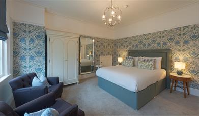 A double room with additional seating options at Florence House Boutique Hotel and Restaurant