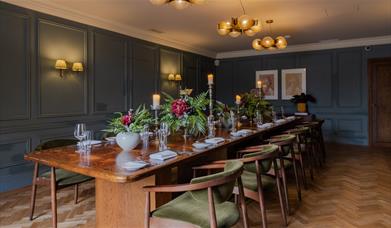 Dining room at Queens Hotel with a long wooden dining table