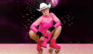 Jennifer Irons in pink skating gear for her show, Bad Immigrant