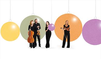 Members of the Bournemouth Symphony Orchestra with their instruments and a background of Christmas baubles