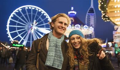 A couple enjoying the Christmas Village at Gunwharf Quays