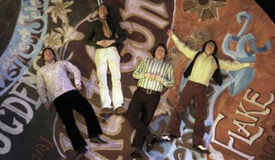 Photograph showing the four members of The Small Fakers