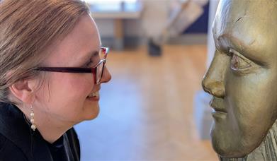 The NMRN's Head of Collections facing a Figurehead