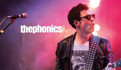 Poster for The Phonics, showing the lead singer mid-performance