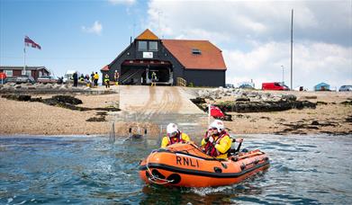 Photograph of a lifeboat heading out of the RNLI station at Eastney