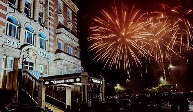 Fireworks going off outside the Queens Hotel for its New Year's Eve ball.