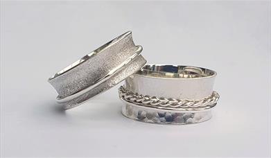 Photograph of two silver spinner rings