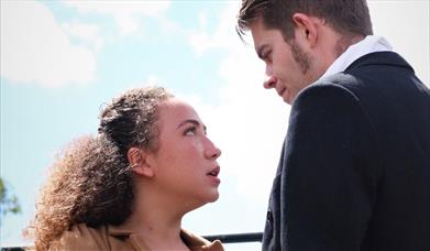 A man and woman from a production of Pride and Prejudice.