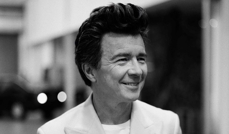 Black and white portrait photograph of Rick Astley