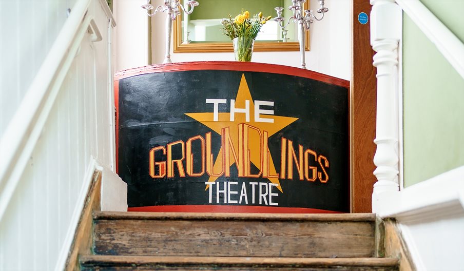 Staircase at the Groundlings Theatre with a painted board at the top