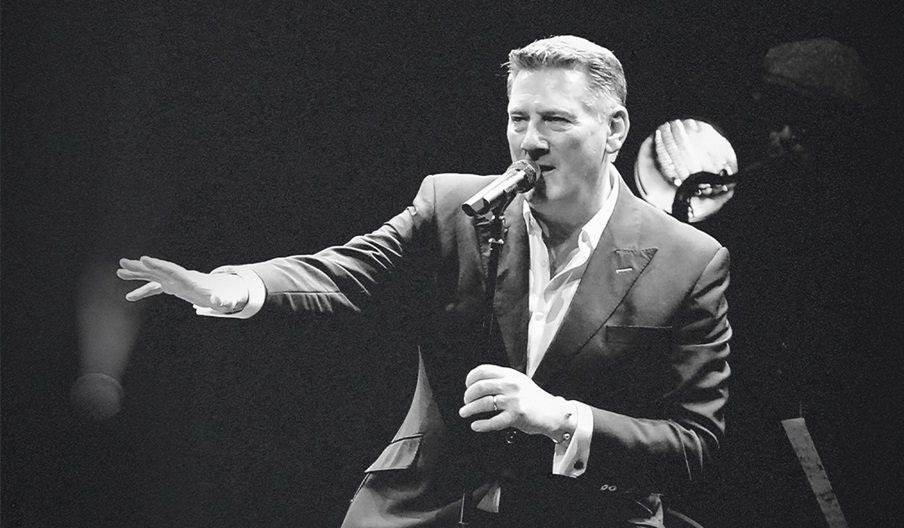 Black and white photograph of Tony Hadley mid-performance
