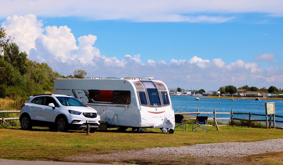 Caravan pitch overlooking the water at Fishery Creek Park