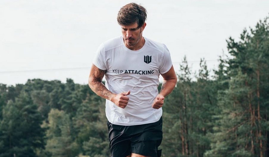 Photograph of a man running in a Keep Attacking t-shirt.