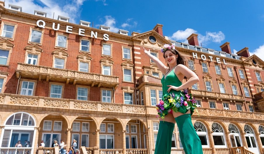 Woman in green outside the Queens Hotel