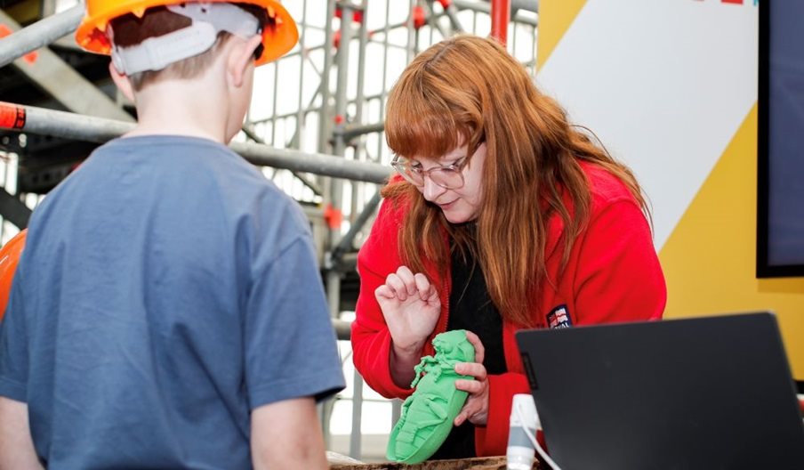 A woman showing a child one of the pests which could impact the ship.
