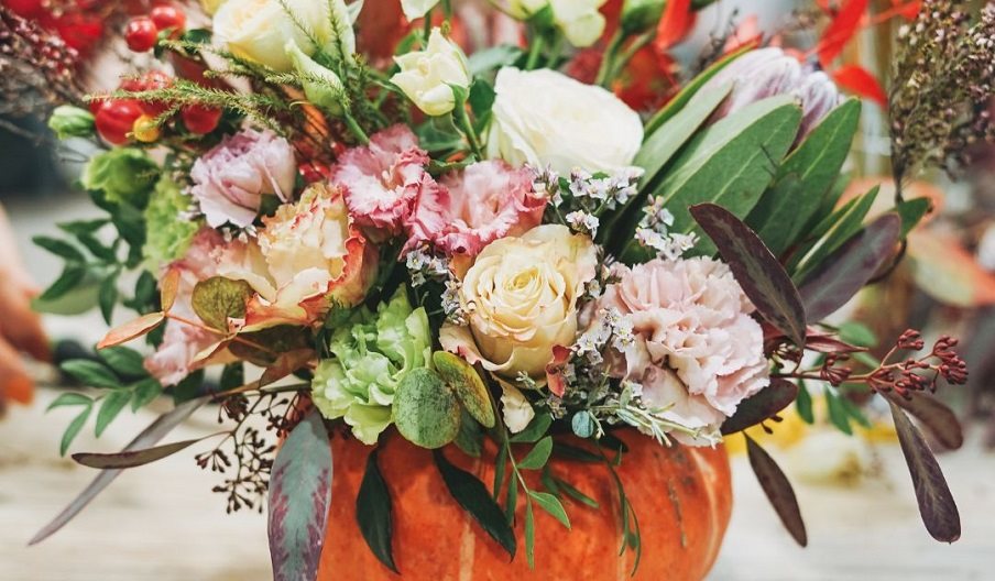 Image of a pumpkin with flowers coming out of the top, for the Pumpkin Floristry Workshop event at Stansted House