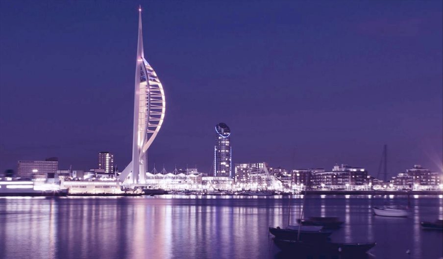 Photograph of the Portsmouth skyline in the R;pple Effect charity's purple colour