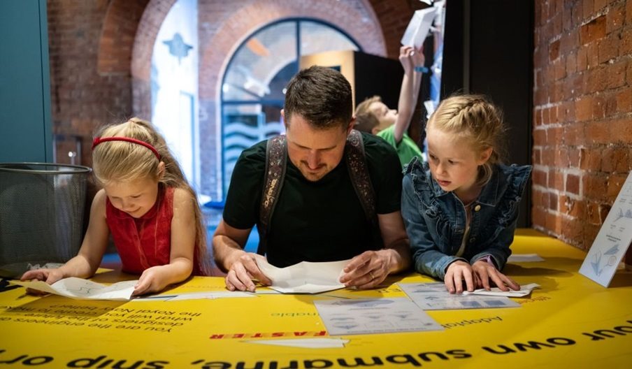 A dad and children enjoying a day out at Portsmouth Historic Dockyard