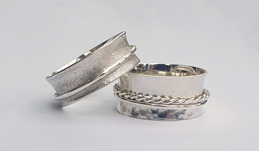 Two silver spinner/worry rings