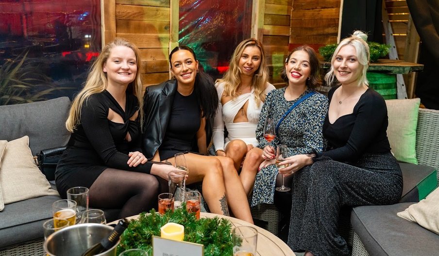 A group of five women enjoying the Winter Lodge at the Queens Hotel