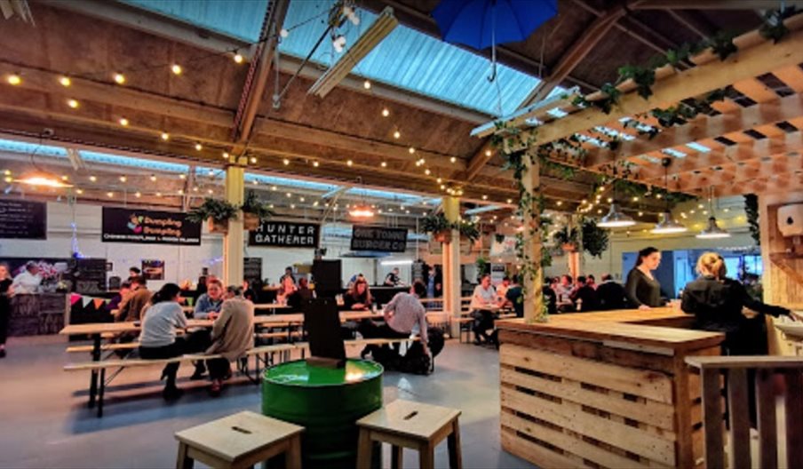 View of the bar, seating and outlets at Outside-In