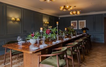 Dining room at Queens Hotel with a long wooden dining table