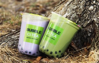 Two milky bubble teas near a tree