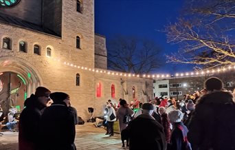 People outside Portsmouth Museum for the Carols on the Green event