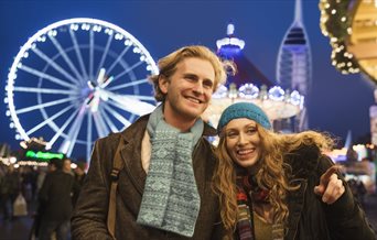 A couple enjoying the Christmas Village at Gunwharf Quays