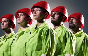 The five members of We Are Not Devo wearing the signature red hats