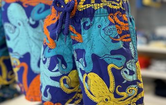 Swim shorts with a multi-coloured octopus design