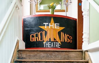 Staircase at the Groundlings Theatre with a painted board at the top